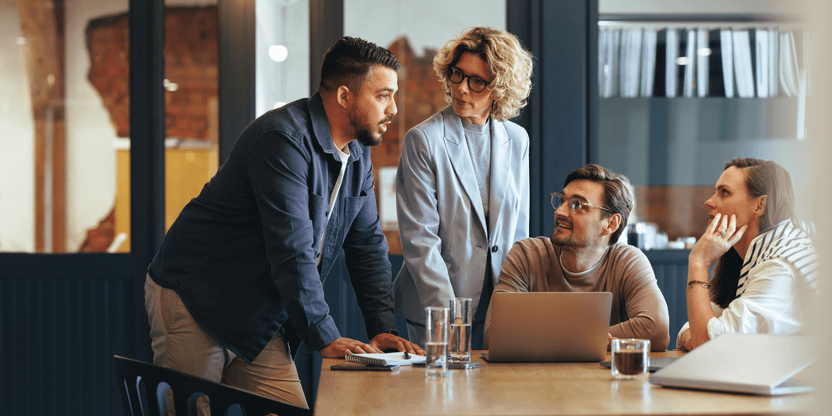 Marketing team collaborating on a Loop Marketing strategy to improve content performance, Answer Engine Optimization (AEO) visibility, and measurable campaign growth.