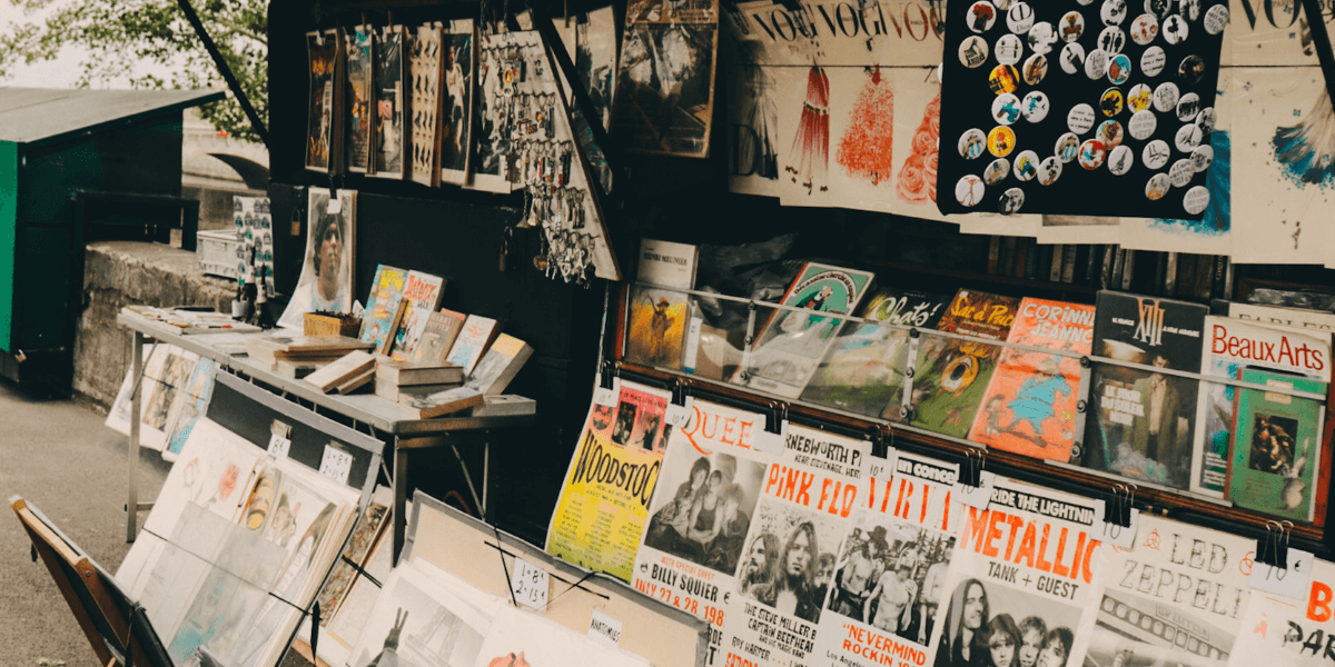 A artist music stand with merchandise for sale.