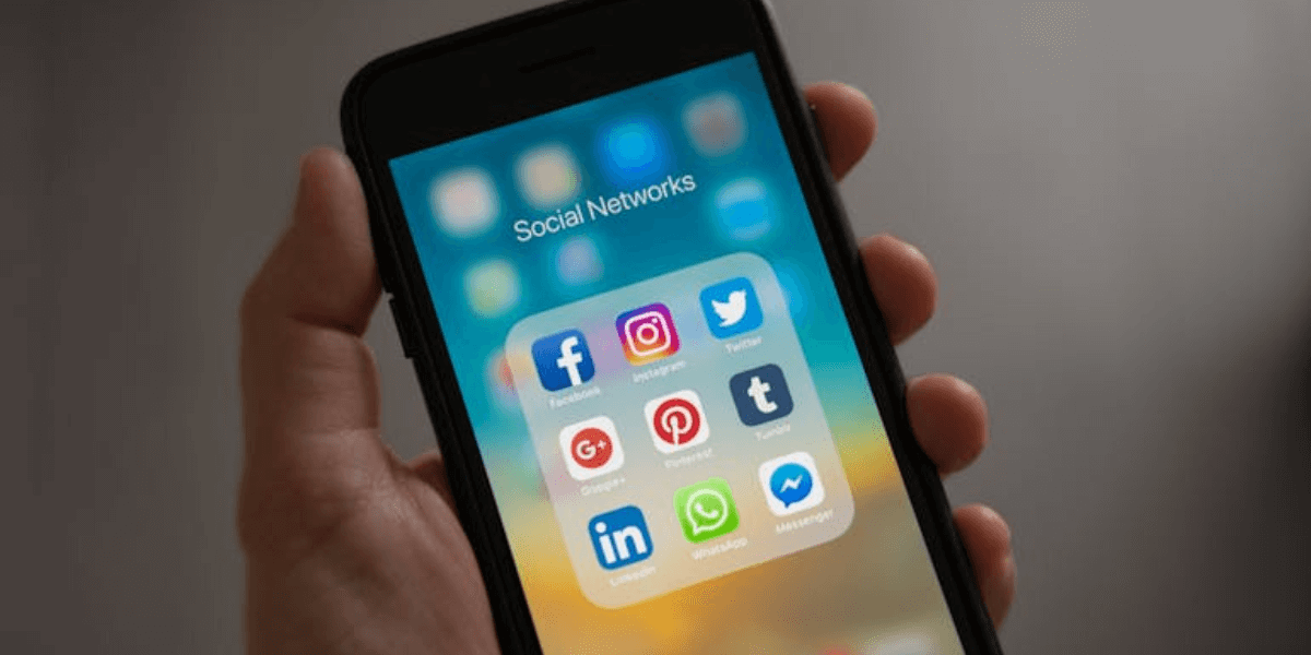 a person holding a smartphone and integrating social media and CRM
