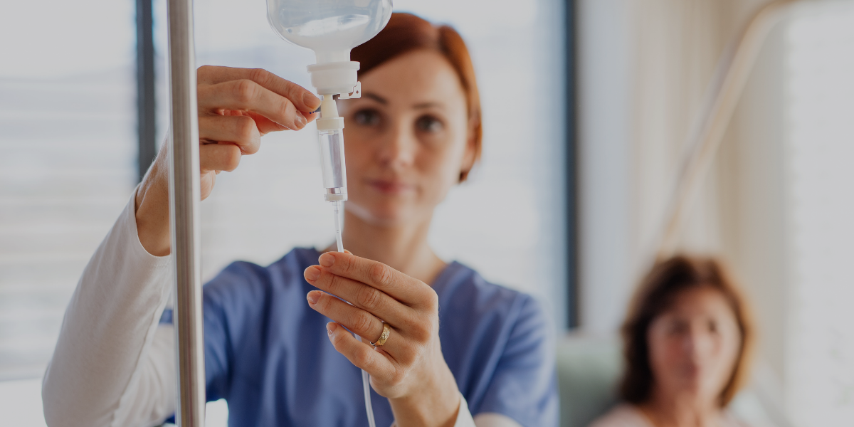 A nurse at NeuroMend IV giving a ketamine drip to a patient.