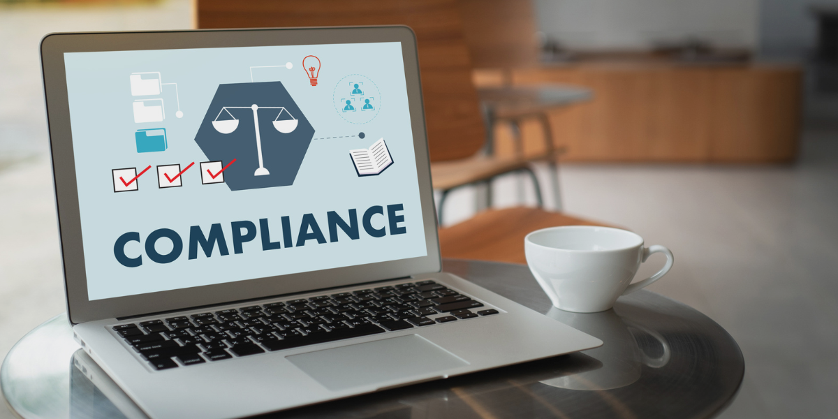 Laptop screen displaying compliance graphics with checkmarks, scales, and icons, representing an ADA compliance audit tool.