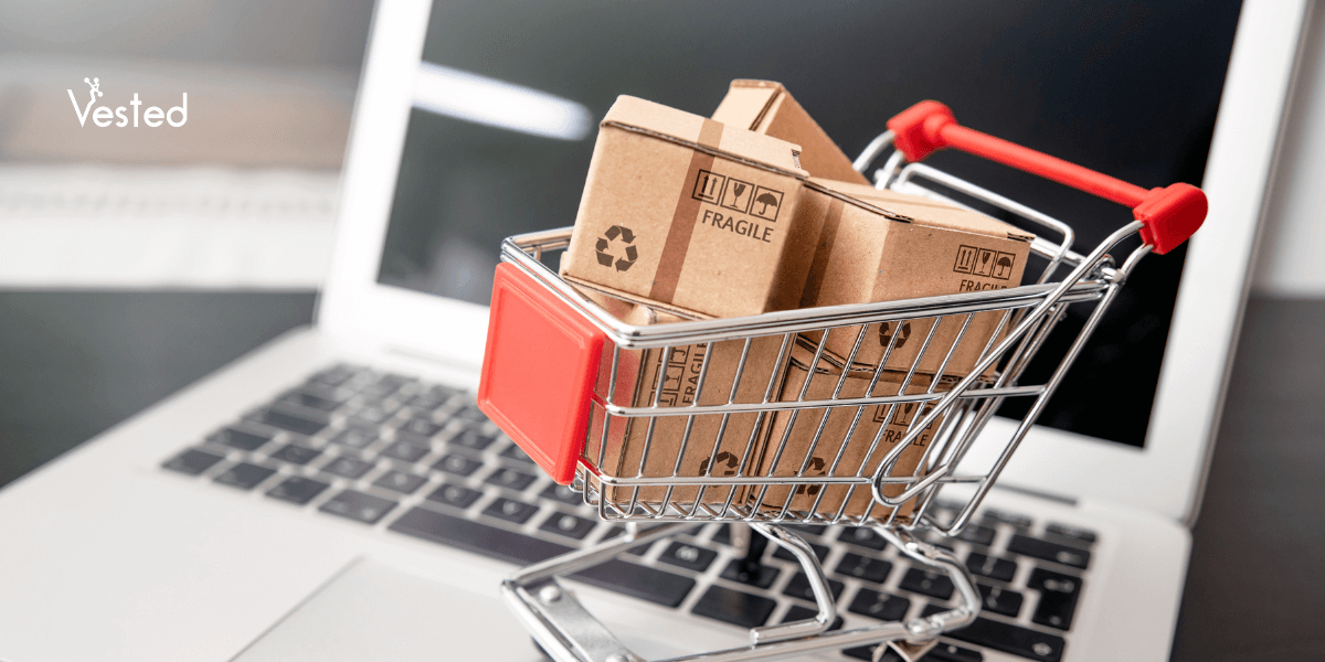 Mini shopping cart with packages on a laptop for e-commerce