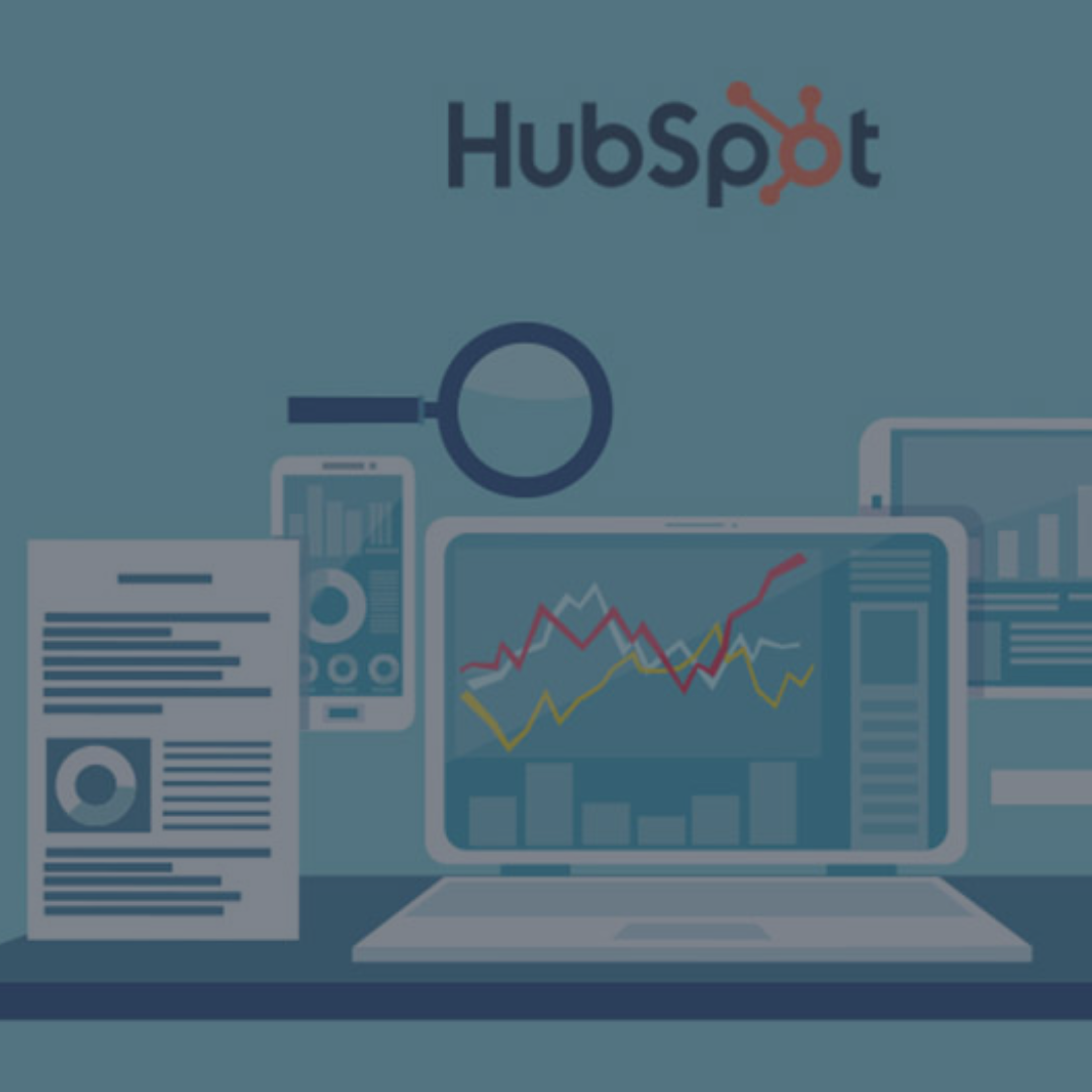 Laptop and mobile icons with graphs on screen representing a HubSpot Portal Audit by Vested Marketing